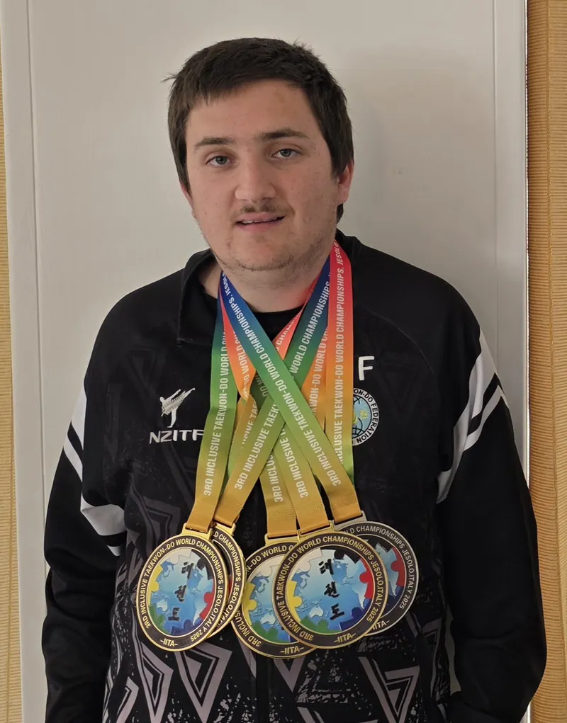 A New Zealand athlete wearing five medals from the 3rd Inclusive Taekwon-Do World Championships